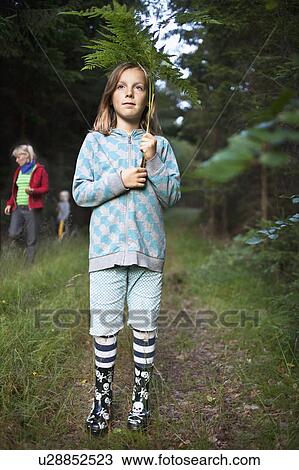 Girl wearing rain boots in forest View Large Photo Image Stock Image - Girl wearing rain boots in forest. Fotosearch