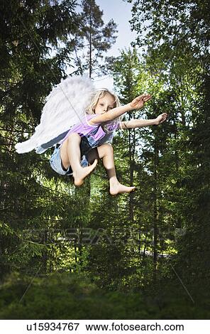 Girl wearing wings and jumping in forest View Large Photo Image Stock Photo - Girl wearing wings and jumping in forest. Fotosearch