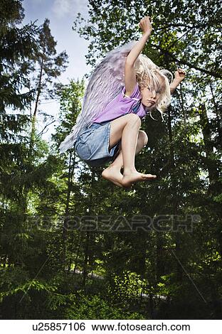 Girl wearing wings and jumping in forest View Large Photo Image Stock Photograph - Girl wearing wings and jumping in forest. Fotosearch