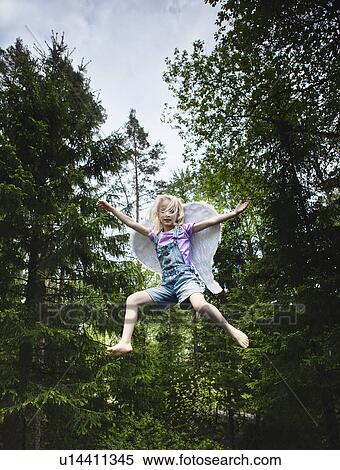 Girl wearing wings and jumping in forest View Large Photo Image Stock Photography - Girl wearing wings and jumping in forest. Fotosearch
