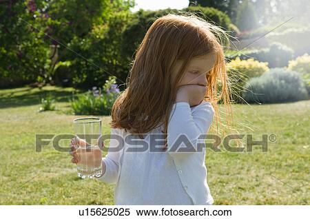 Girl with glass of water in backyard View Large Photo Image Stock Photography - Girl with glass of water in backyard. Fotosearch