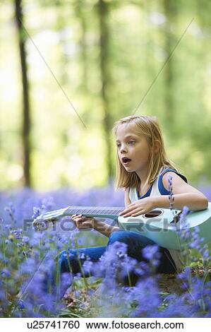 Girl with guitar in field of flowers View Large Photo Image Stock Image - Girl with guitar in field of flowers. Fotosearch