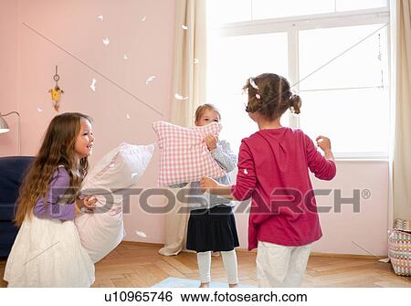 Girls having a pillow fight View Large Photo Image Stock Photograph - Girls having a pillow fight. Fotosearch