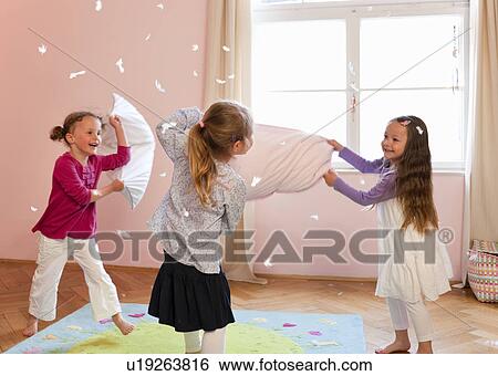 Girls having a pillow fight View Large Photo Image Stock Photograph - Girls having a pillow fight. Fotosearch