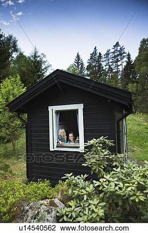 Girls looking out window of shack View Large Photo Image Stock Image - Girls looking out window of shack. Fotosearch