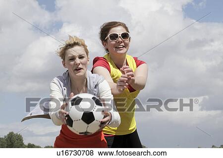 Stock Photo - Girls playing soccer together. Fotosearch