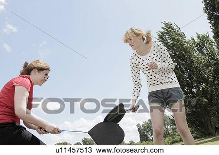 Girls playing with rackets in park View Large Photo Image Stock Image - Girls playing with rackets in park. Fotosearch