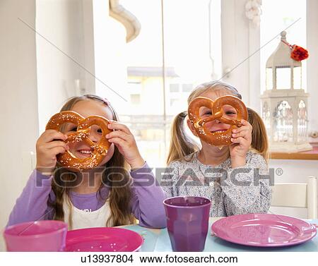 Girls playing with their food at table View Large Photo Image Picture - Girls playing with their food at table. Fotosearch