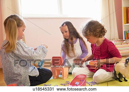 Girls playing with toys together View Large Photo Image Stock Image - Girls playing with toys together. Fotosearch
