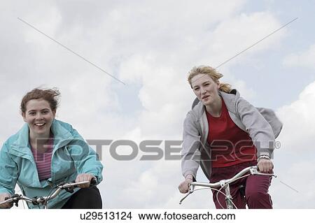 Girls riding bikes outdoors View Large Photo Image Picture - Girls riding bikes outdoors. Fotosearch