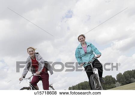 Girls riding bikes outdoors View Large Photo Image Stock Photo - Girls riding bikes outdoors. Fotosearch