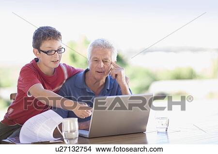 Grandfather and grandson using laptop View Large Photo Image Picture - Grandfather and grandson using laptop. Fotosearch
