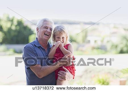 Grandfather holding granddaughter View Large Photo Image Stock Image - Grandfather holding granddaughter. Fotosearch