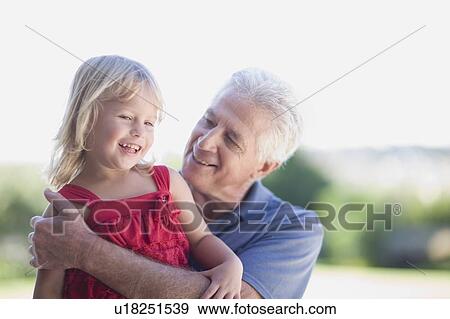 Stock Photo - Grandfather hugging granddaughter. Fotosearch