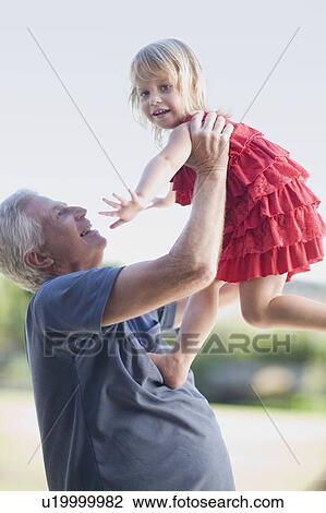 Grandfather playing with granddaughter View Large Photo Image Stock Image - Grandfather playing with granddaughter. Fotosearch