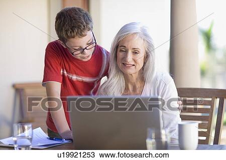 Grandmother and grandson using laptop View Large Photo Image Stock Image - Grandmother and grandson using laptop. Fotosearch