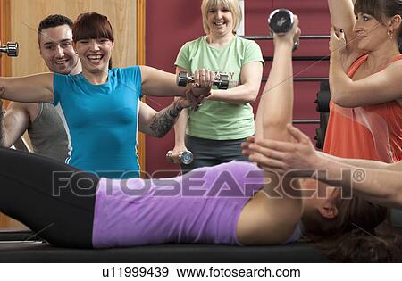 Group of people exercising in gym View Large Photo Image Stock Photo - Group of people exercising in gym. Fotosearch