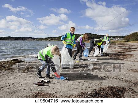 Group of workers cleaning beach View Large Photo Image Stock Photograph - Group of workers cleaning beach. Fotosearch