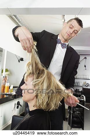 Stock Photo - Hairdresser cutting woman’s hair. Fotosearch