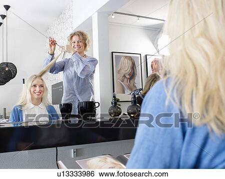 Hairdresser cutting woman’s hair View Large Photo Image Stock Photograph - Hairdresser cutting woman’s hair. Fotosearch