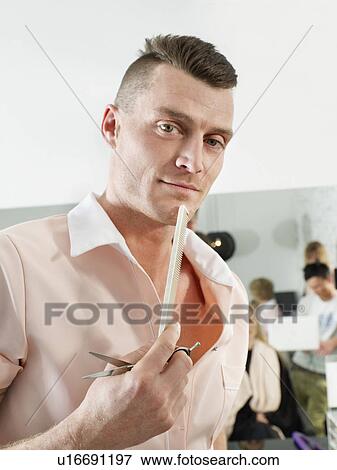 Hairdresser holding comb and scissors View Large Photo Image Stock Photo - Hairdresser holding comb and scissors. Fotosearch