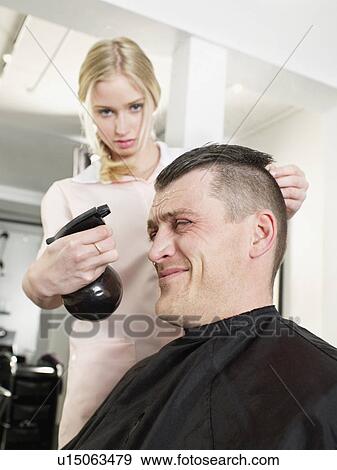 Hairdresser spritzing man’s hair View Large Photo Image Stock Photo - Hairdresser spritzing man’s hair. Fotosearch