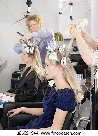 Picture - Hairdressers at work in salon. Fotosearch