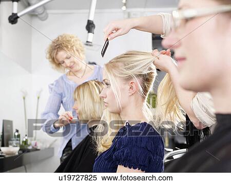 Stock Photography - Hairdressers at work in salon. Fotosearch