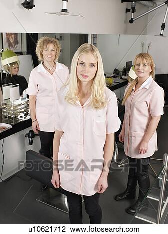 Stock Image - Hairdressers standing in salon. Fotosearch