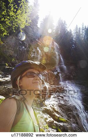 Hiker admiring landscape on hillside View Large Photo Image Stock Image - Hiker admiring landscape on hillside. Fotosearch