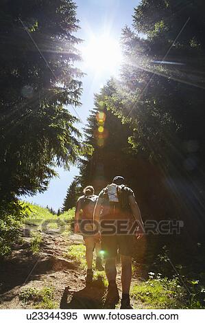 Stock Photography - Hikers walking uphill in forest. Fotosearch