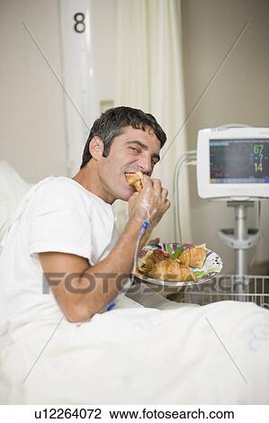 Hospital patient eating in bed View Large Photo Image Stock Image - Hospital patient eating in bed. Fotosearch