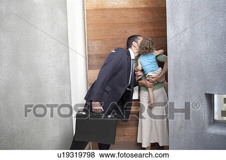 Stock Photo - Husband kissing wife before work. Fotosearch
