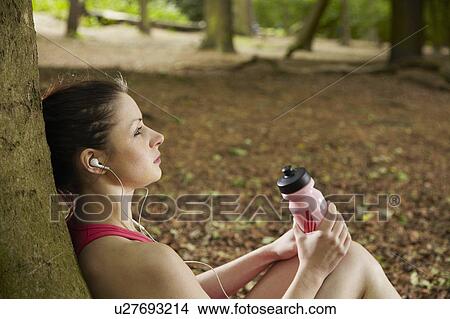 Jogger listening to mp3 player in forest View Large Photo Image Picture - Jogger listening to mp3 player in forest. Fotosearch