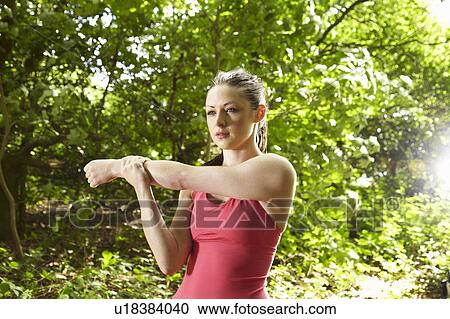 Jogger stretching in forest View Large Photo Image Stock Image - Jogger stretching in forest. Fotosearch