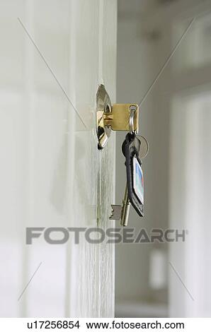 Picture - Keys in lock of front door. Fotosearch