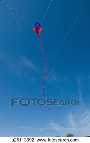 Kite flying in blue sky View Large Photo Image Stock Image - Kite flying in blue sky. Fotosearch