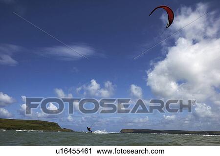 Kite surfer on water under blue sky View Large Photo Image Stock Image - Kite surfer on water under blue sky. Fotosearch
