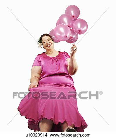 Large woman holding bunch of balloons View Large Photo Image Picture - Large woman holding bunch of balloons. Fotosearch