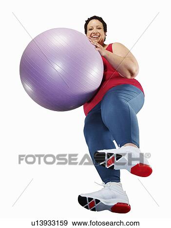 Large woman holding exercise ball View Large Photo Image Stock Photo - Large woman holding exercise ball. Fotosearch