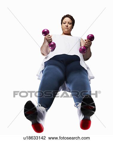 Stock Image - Large woman lifting weights. Fotosearch