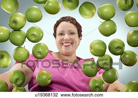 Large woman with green apples View Large Photo Image Stock Image - Large woman with green apples. Fotosearch