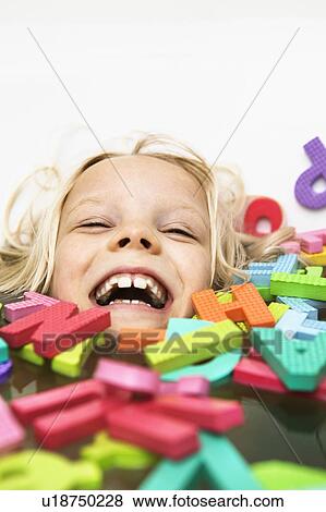 Laughing child playing with foam letters View Large Photo Image Stock Photo - Laughing child playing with foam letters. Fotosearch