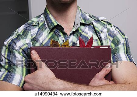 Leaves in businessman’s folder View Large Photo Image Picture - Leaves in businessman’s folder. Fotosearch