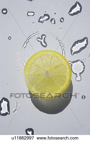 Stock Photo - Lemon slice and water droplets. Fotosearch