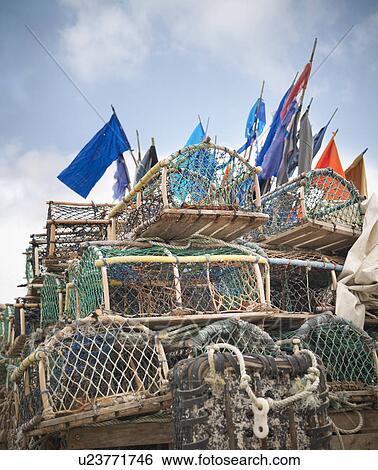 Stock Photograph - Lobster pots with flags on deck. Fotosearch