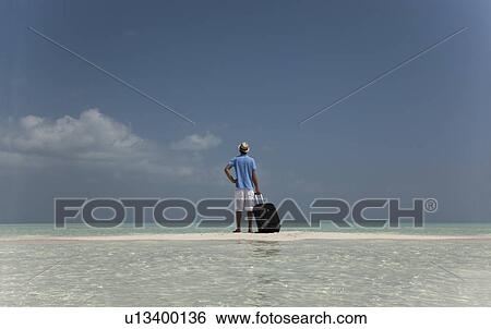 Lost man with luggage on beach View Large Photo Image Stock Photograph - Lost man with luggage on beach. Fotosearch