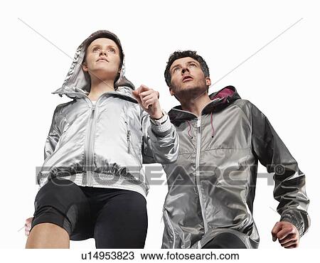 Low angle view of couple jogging View Large Photo Image Stock Image - Low angle view of couple jogging. Fotosearch