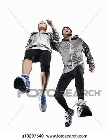 Low angle view of couple jogging View Large Photo Image Stock Image - Low angle view of couple jogging. Fotosearch