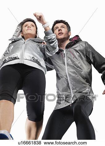 Low angle view of couple jogging View Large Photo Image Stock Photo - Low angle view of couple jogging. Fotosearch